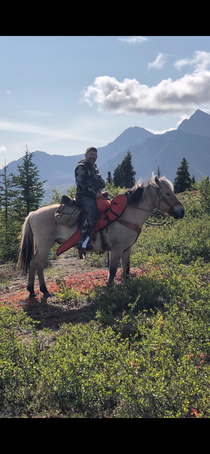 Tom Anderson on horseback in high mountain country