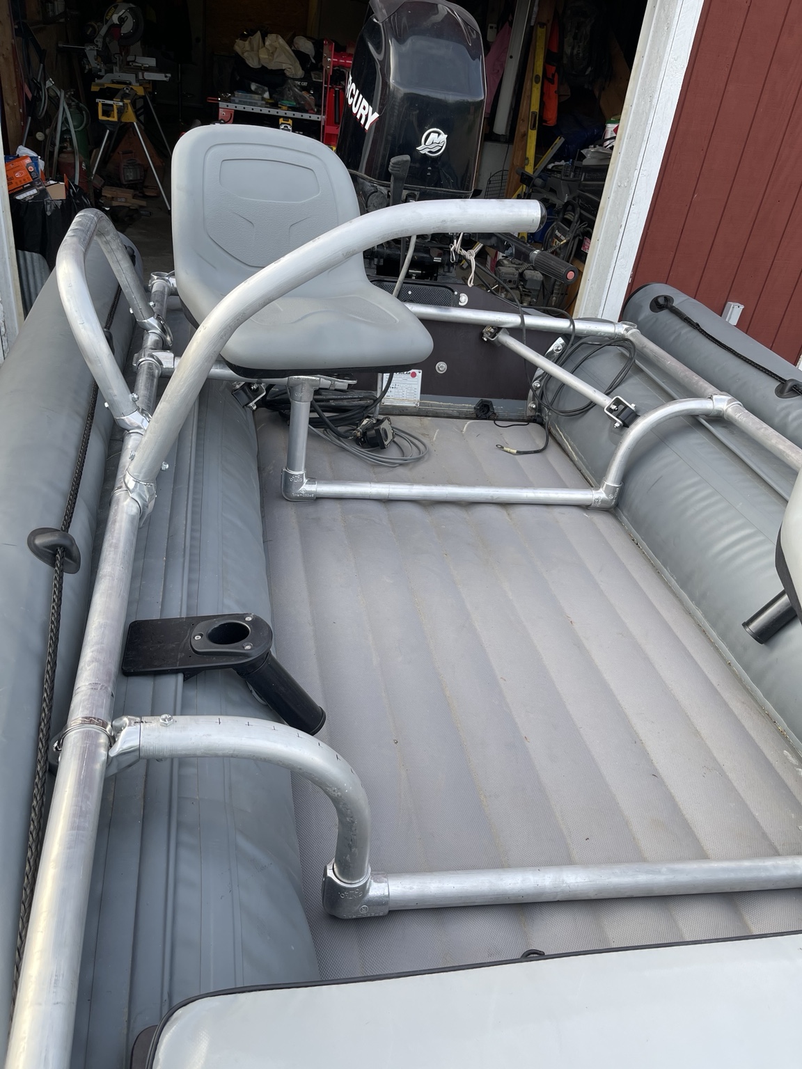 Interior aluminum tubing frame, seat mount, and cup holder inside a custom-rigged inflatable boat
